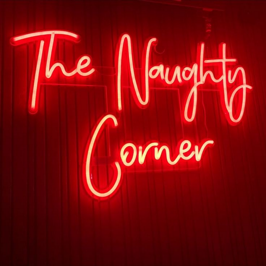 The Naughty Corner neon sign in vibrant red