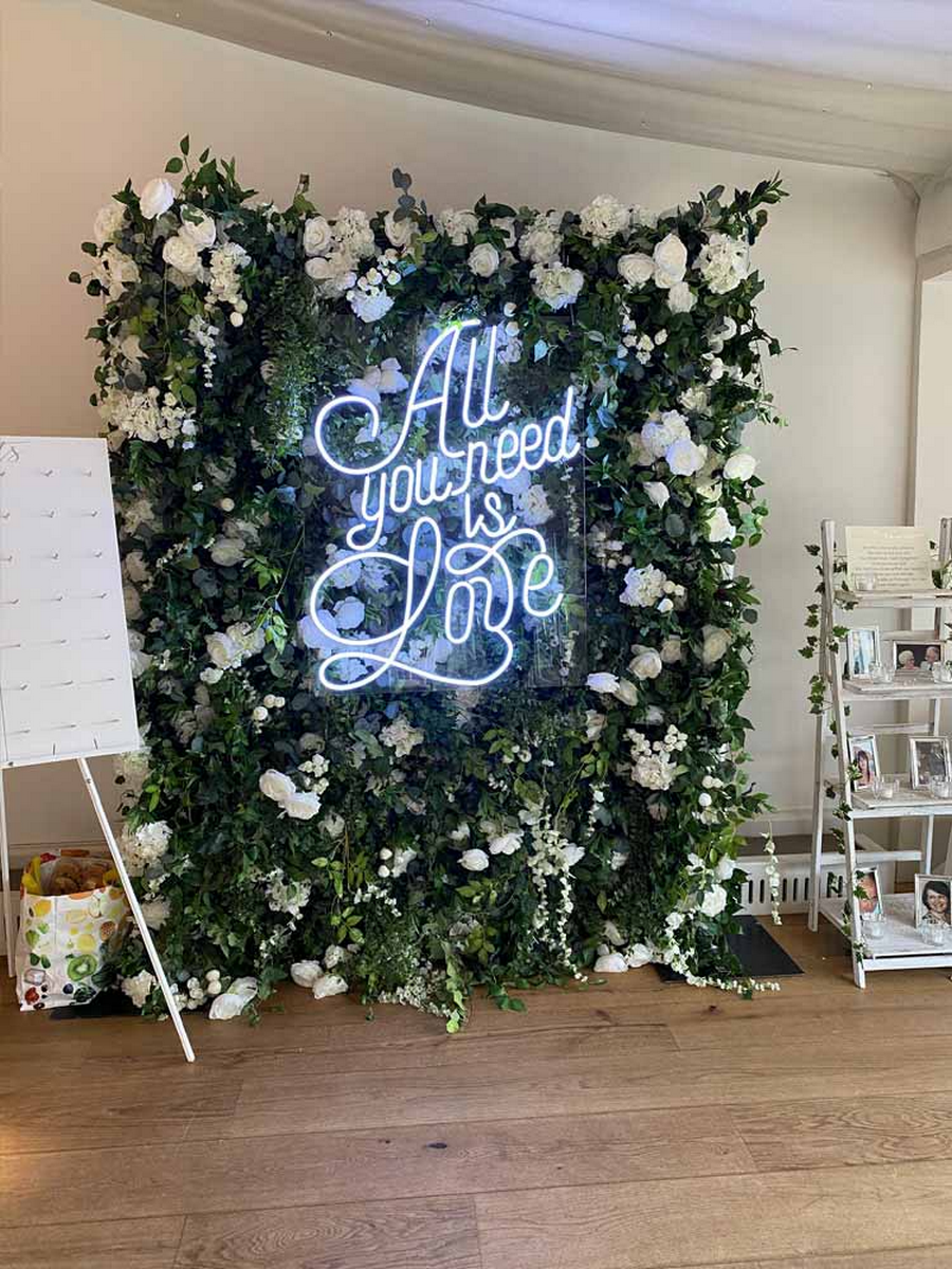 Elegant floral walls with light blue neon sign on top