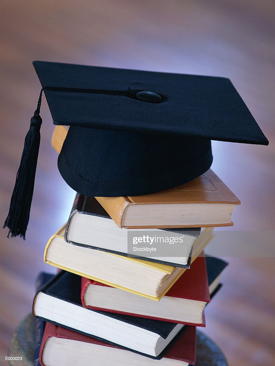 Books stacked with graduation caps on tops as centerpieces