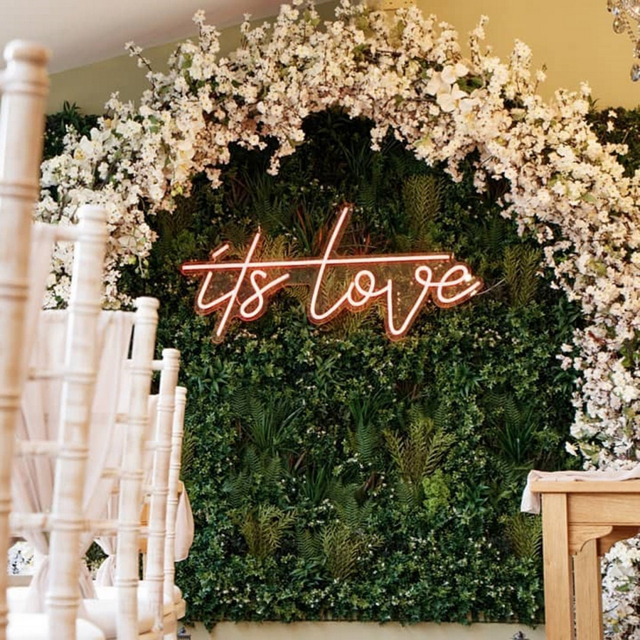 its love LED neon sign on floral arch