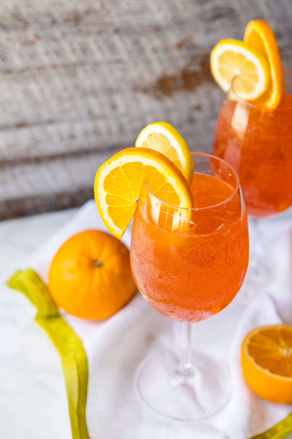 Photo of Mayhaw Aperol Spritz in large wine glasses