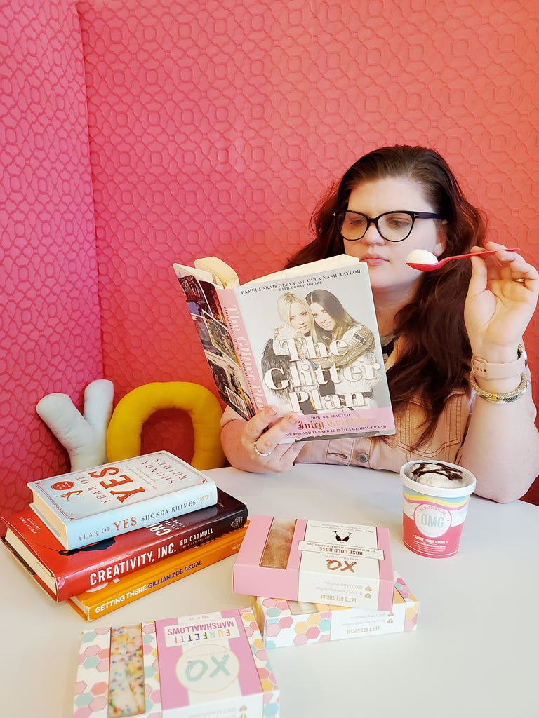 Kat Connor, co founder of XO Marshmallow, reading The Glitter Plan while eating marshmallow fluff