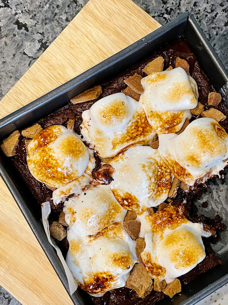 S'mores brownies made with XO marshmallow hot cocoa mix topped with toasted vanilla marshmallows