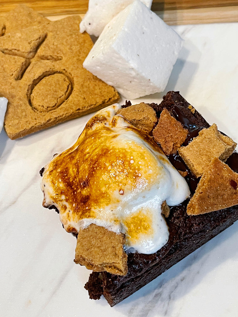 S'mores brownies made with XO marshmallow hot cocoa mix topped with toasted vanilla marshmallows