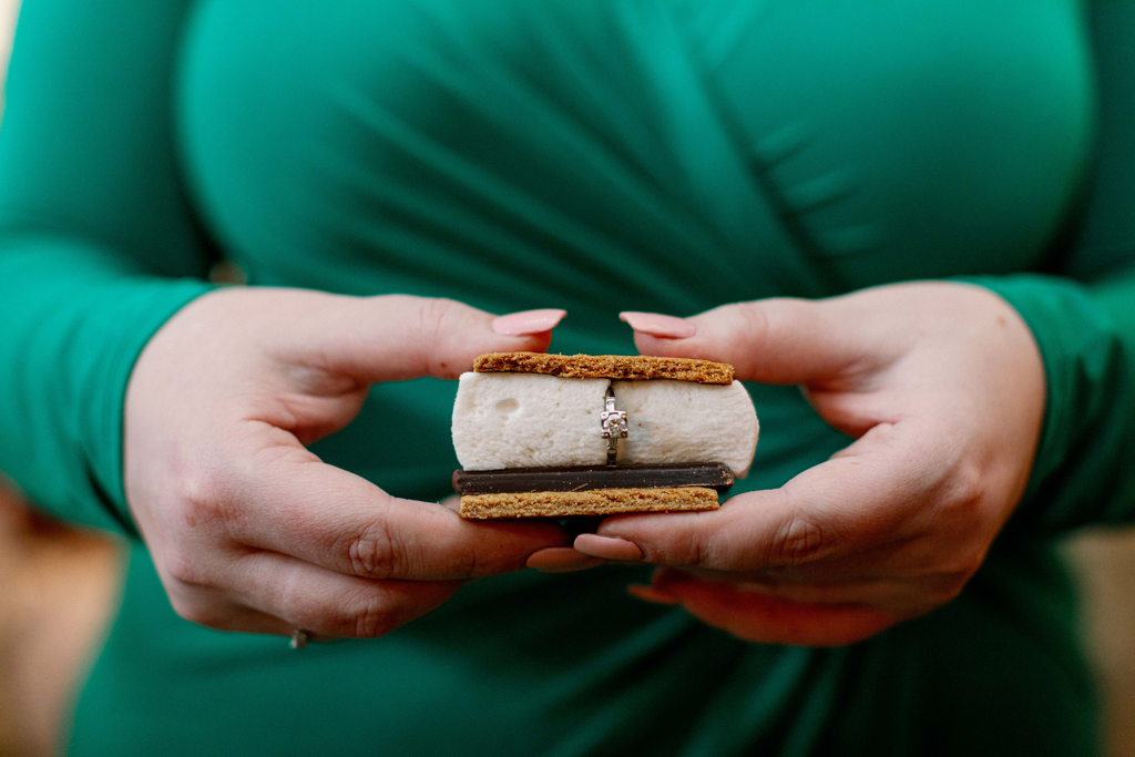 Kat Connor holds a s'more with her engagement ring inside