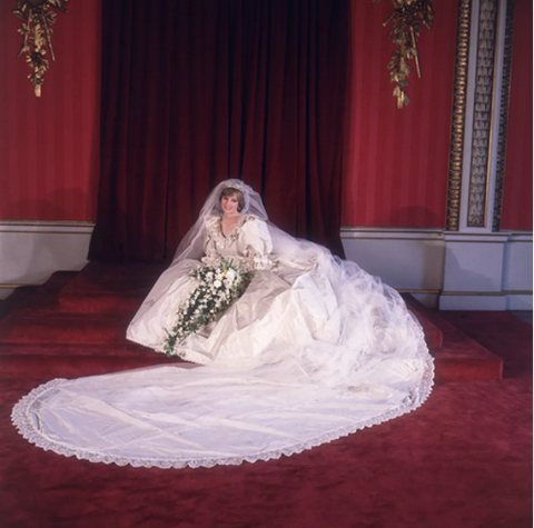 Princess Diana surrounded by her wedding dress train and floral fountain