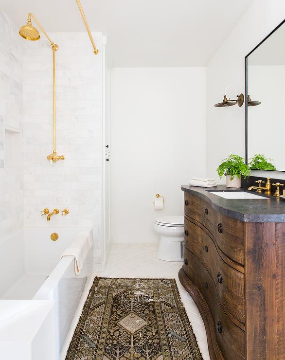 transitional bathroom with gold fixtures and shower curtain rail