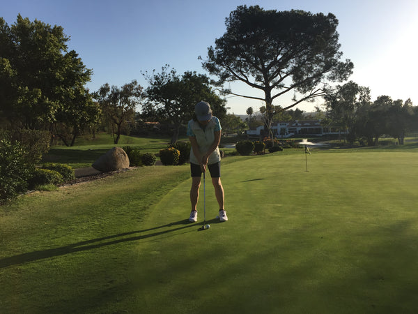 A student from a golf course in San Diego practicing his swing