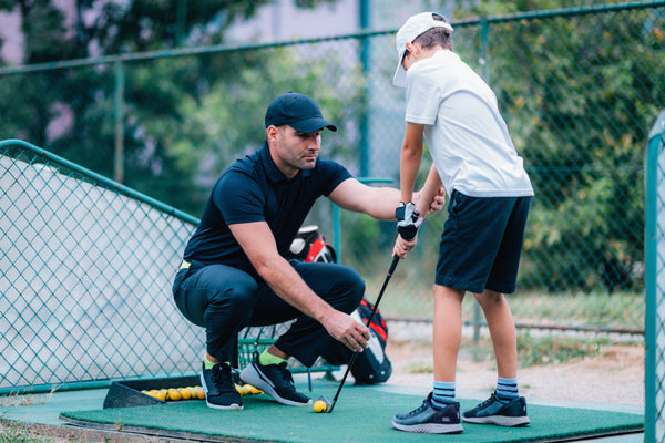 A golf professional gets in contact with student for his golf lessons