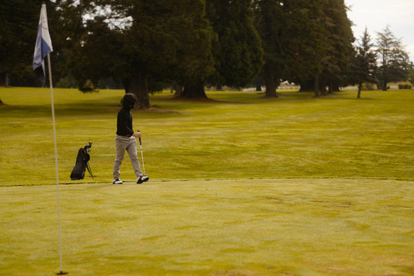 after tee time this golfer is standing behind the slow group ahead