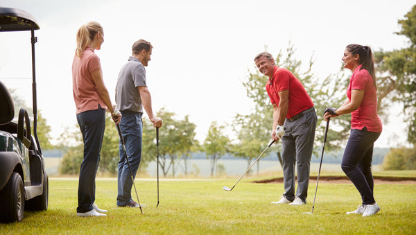 Golfers and their playing partner practicing golf in the putting greens