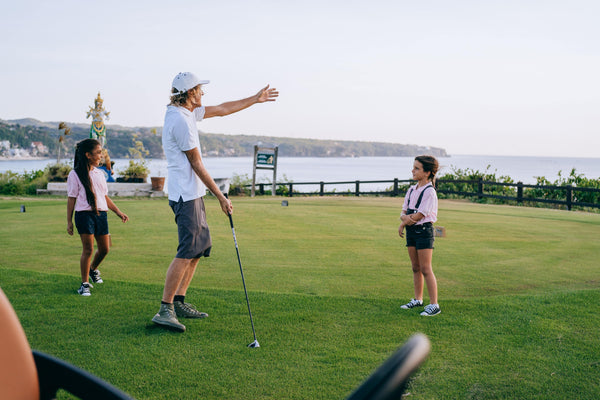 Golf trainers in San Diego teaching golf lessons to children by their own capacity