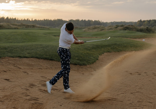 a person from a group practice swings and leaves behind ball marks