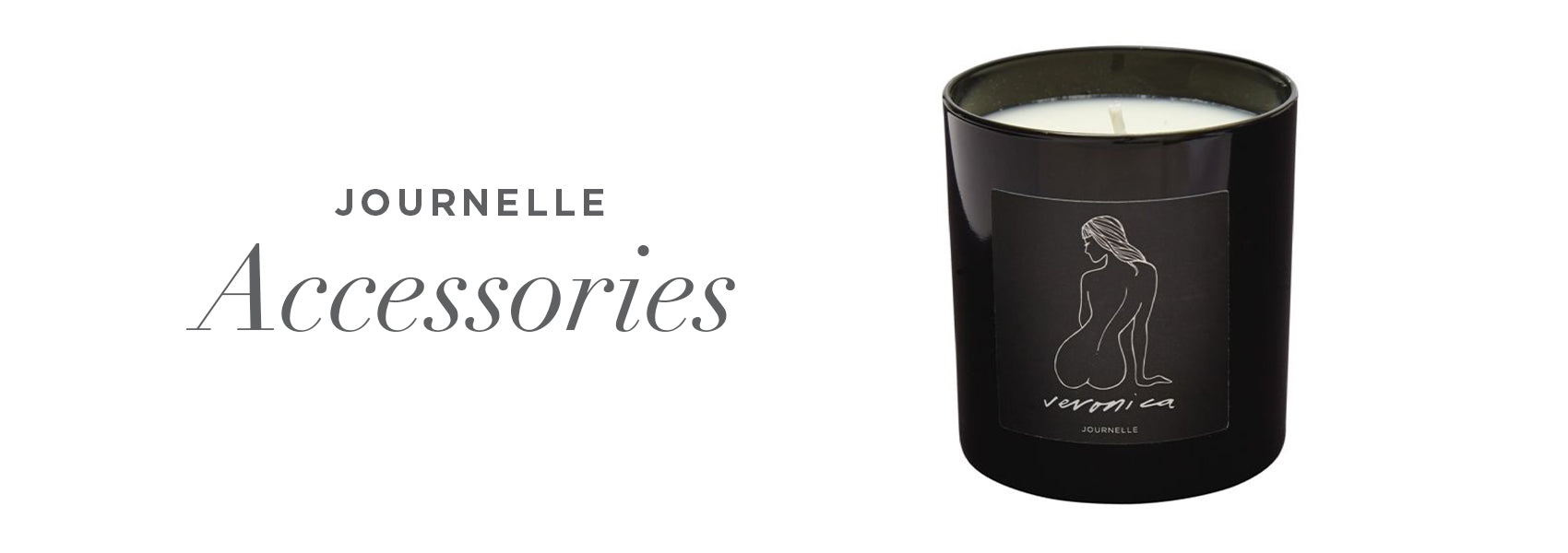 Image of the Journelle veronica candle. Candle is black with a line drawing of a woman. Text says, "Journelle Accessories" 