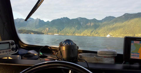 Ocean and mountains seen through from window of boat