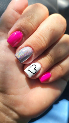 pink nails with white accent finger and black outlined heart