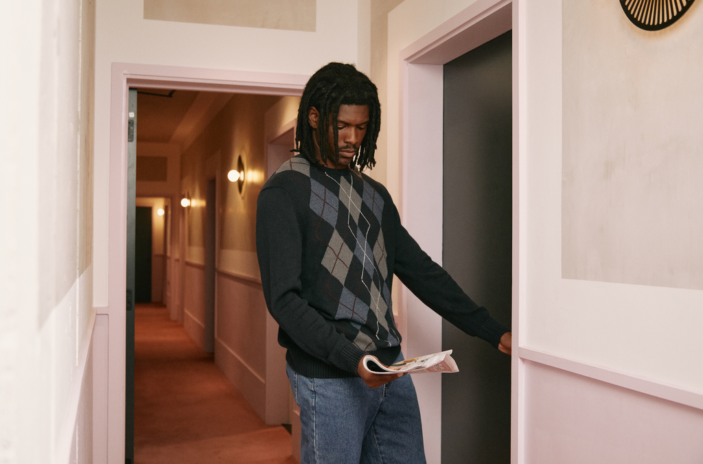 man wears vintage leather jacket in motel