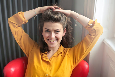 girl yellow shirt smiling