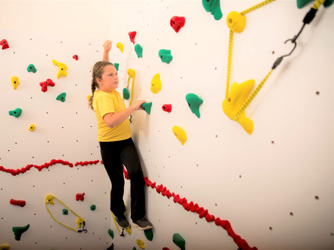 Girl rock climbing avoiding challenges