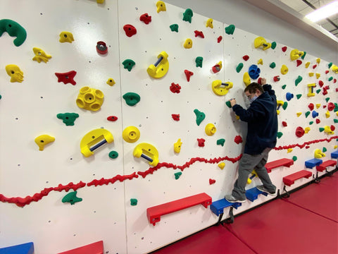 Boy climbing on Adaptive Wall by Everlast Climbing