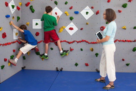 Students rock climbing and spelling words