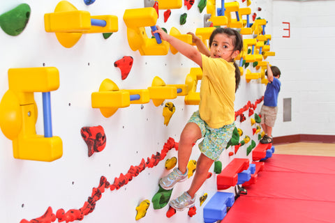 Girl climbing on an Adaptive Climbing Wall