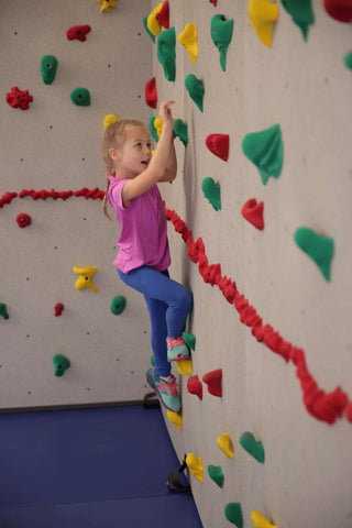 Girl climbing on a Traverse Wall