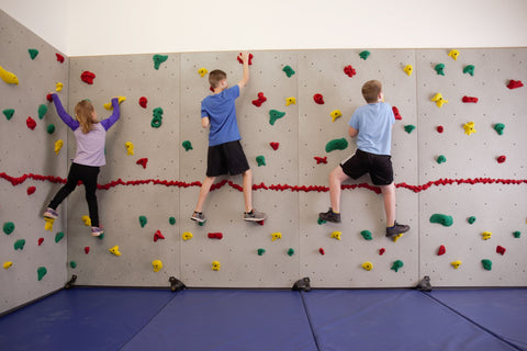 Children rock climbing on a Traverse Wall