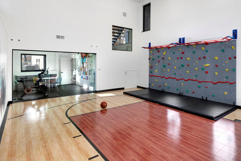 Home climbing wall with sport court
