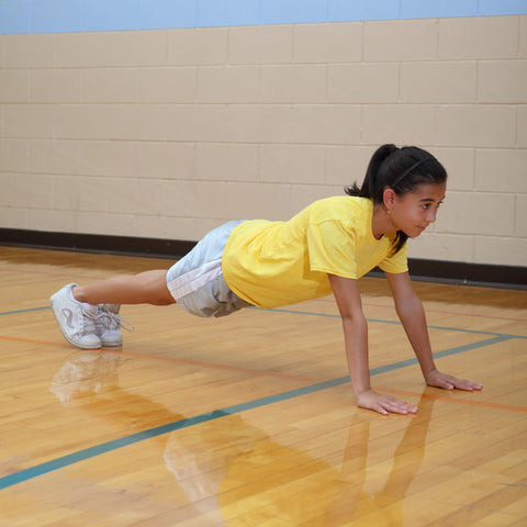 Girl performing a high plank to build muscle strength for rock climbing