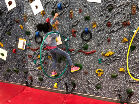 Students climbing on a Traverse Wall using ring holds