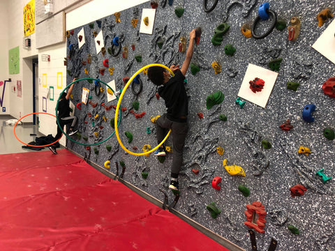 Students climbing on a Traverse Wall through Versa Challenge Course accessory