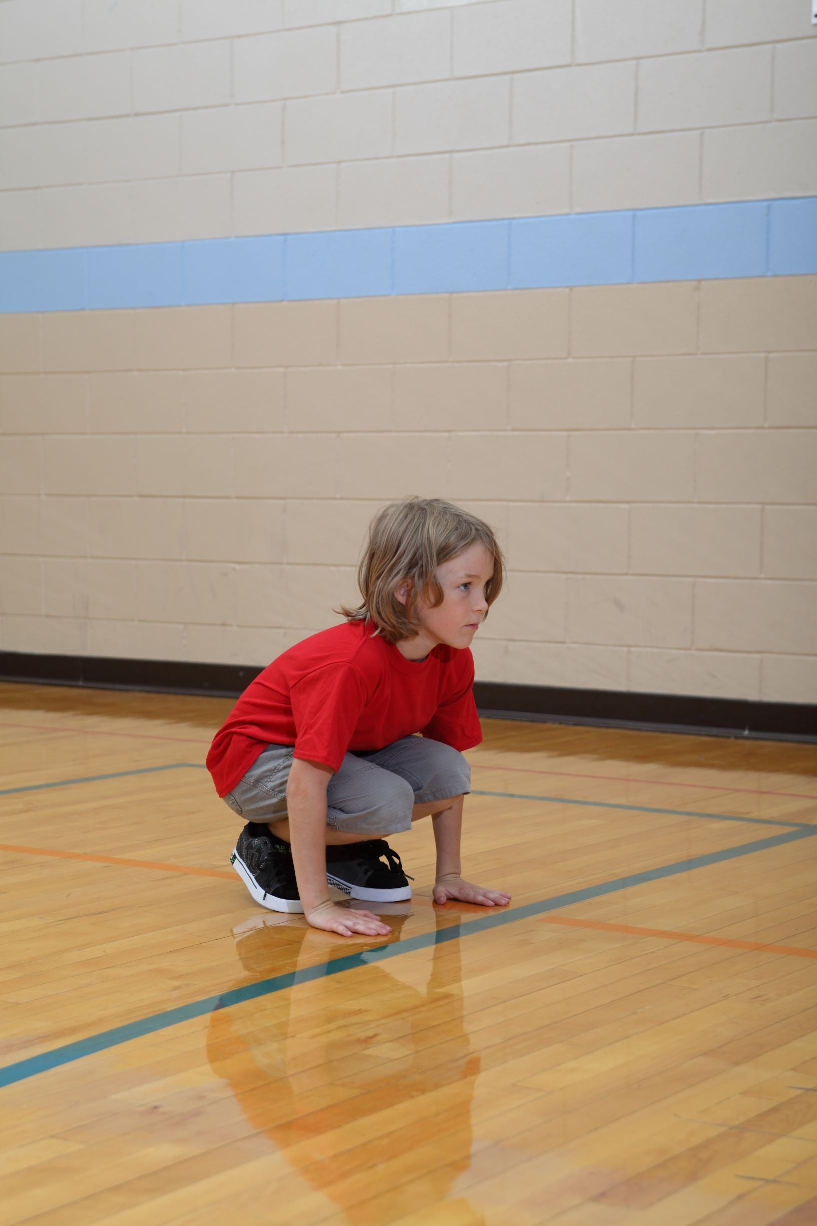 Boy performing squat thrust to build muscular strength