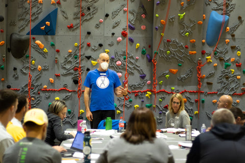 Everlast Climbing trainer training staff on how to use a climbing wall