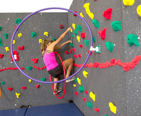 Girl rock climbing through the Versa Challenge Course on a Traverse Wall by Everlast Climbing