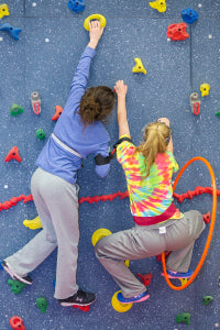 Girls climbing on magna traverse wall