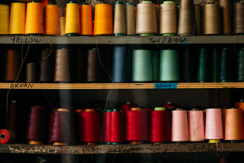 assorted colors of threads on a spool