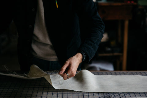 a person cutting thread on their workstation