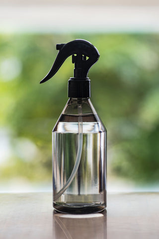 water in a spray bottle on top of a table