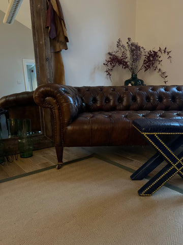 Antique leather chesterfield sofa in london showroom