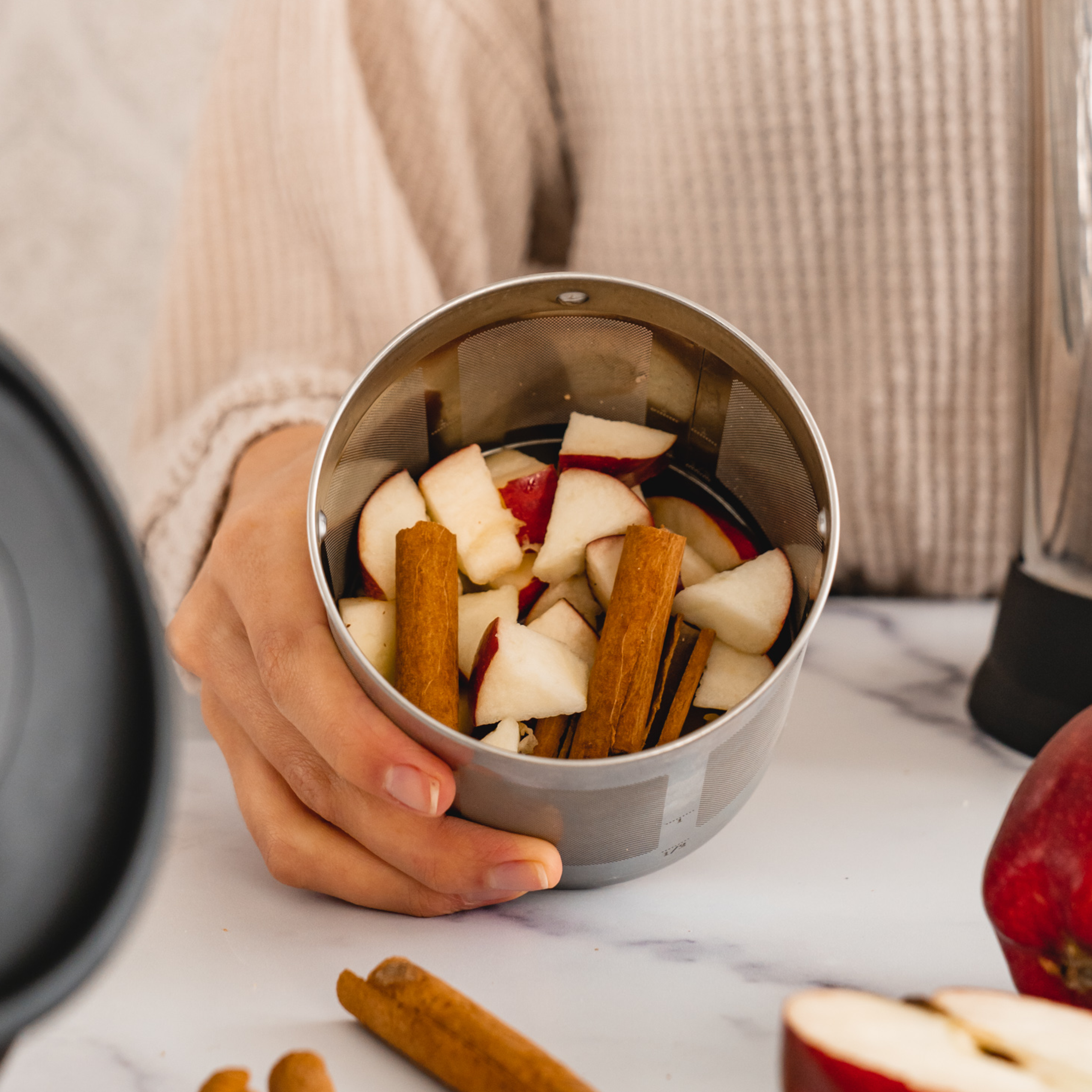 chopped apples and cinnamon in an almond cow filter basket