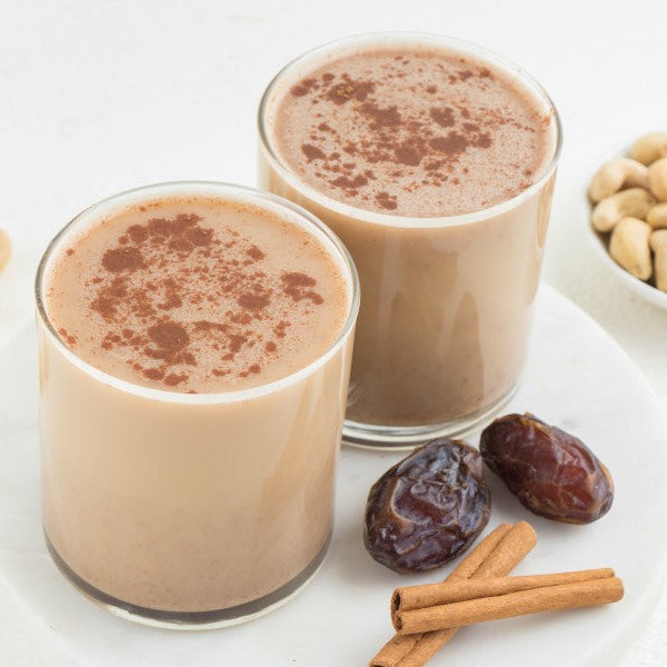 vegan cashew milk chai lattes next to cinnamon and dates