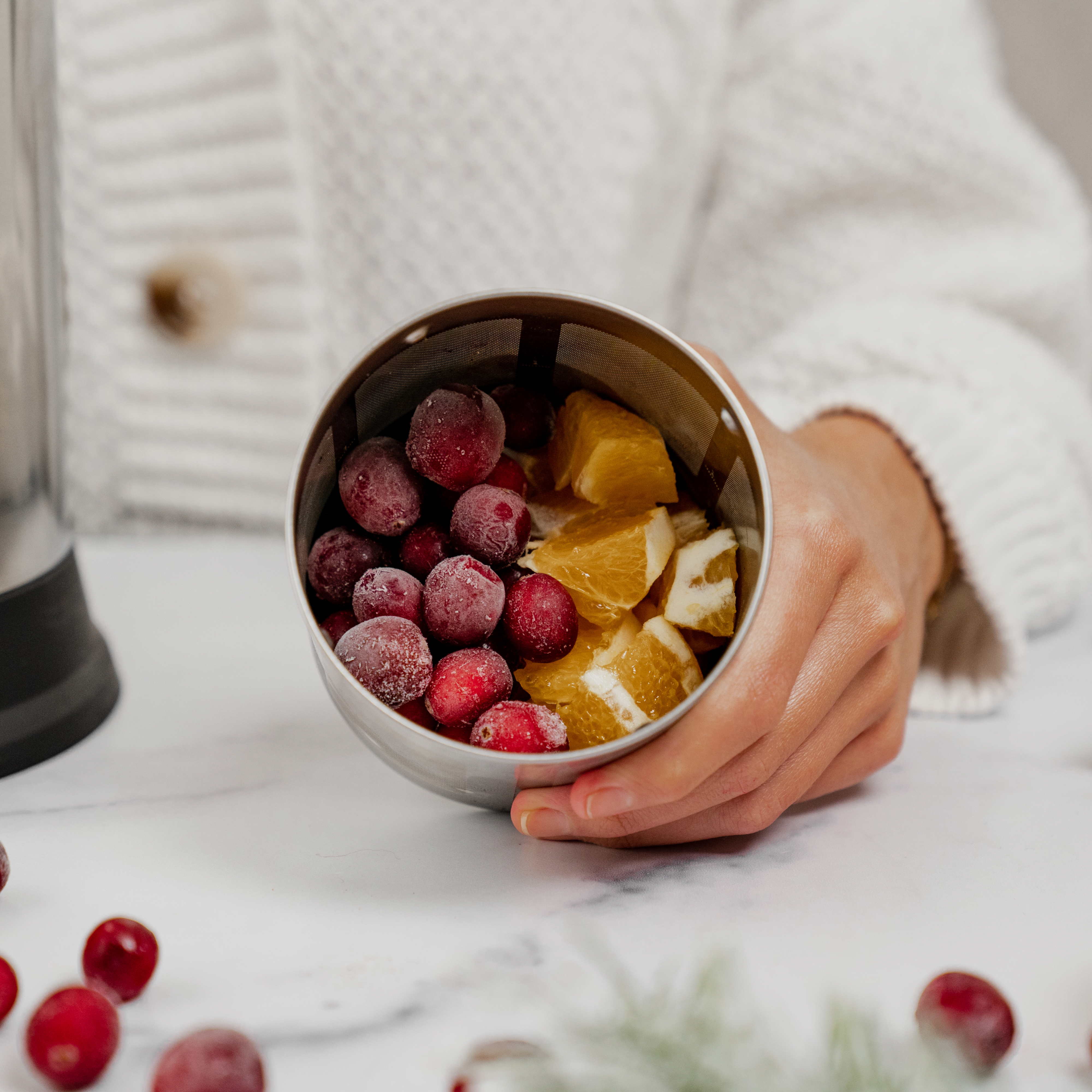 cranberries, oranges in a filter basket 