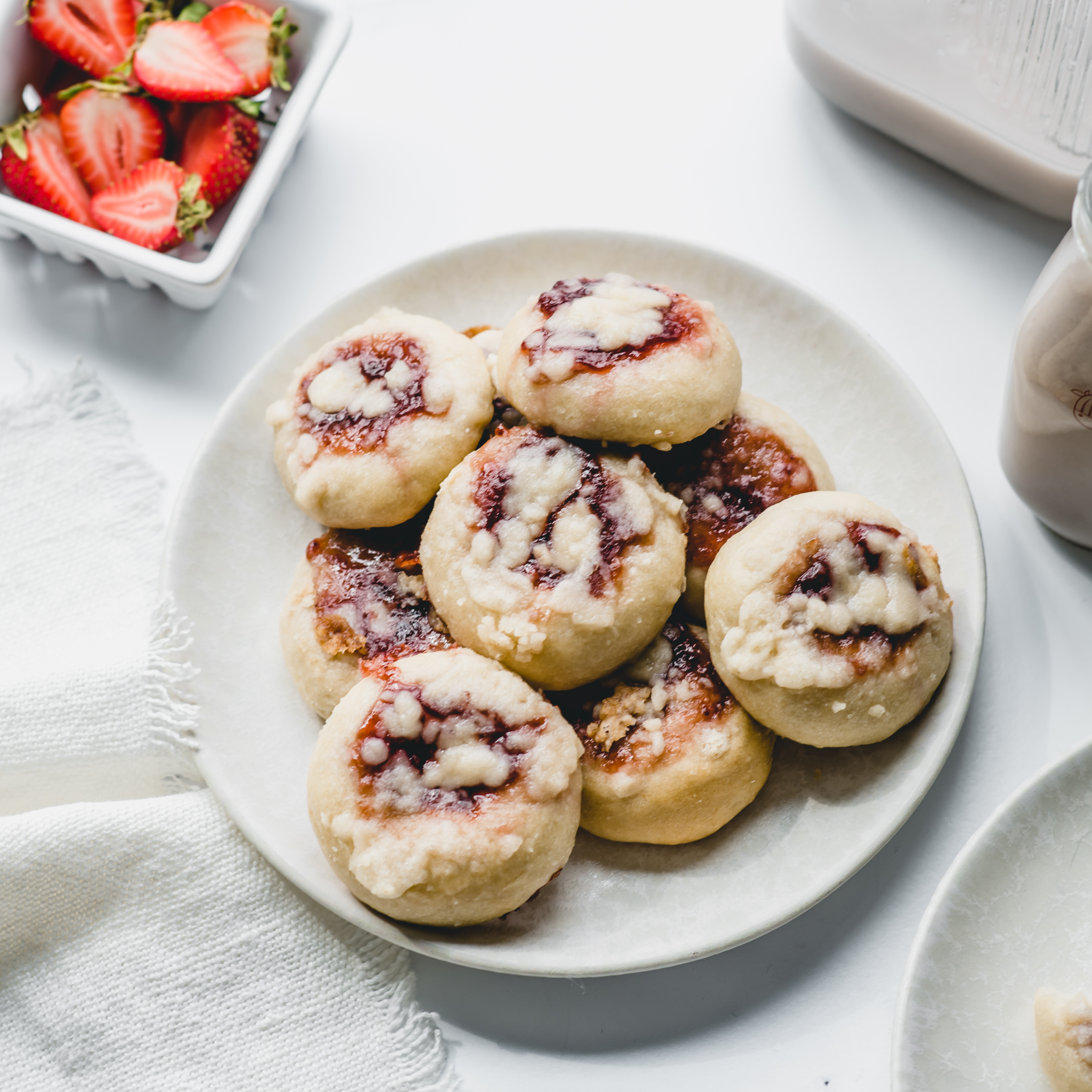 Strawberry Kolaches on a white plate with strawberries