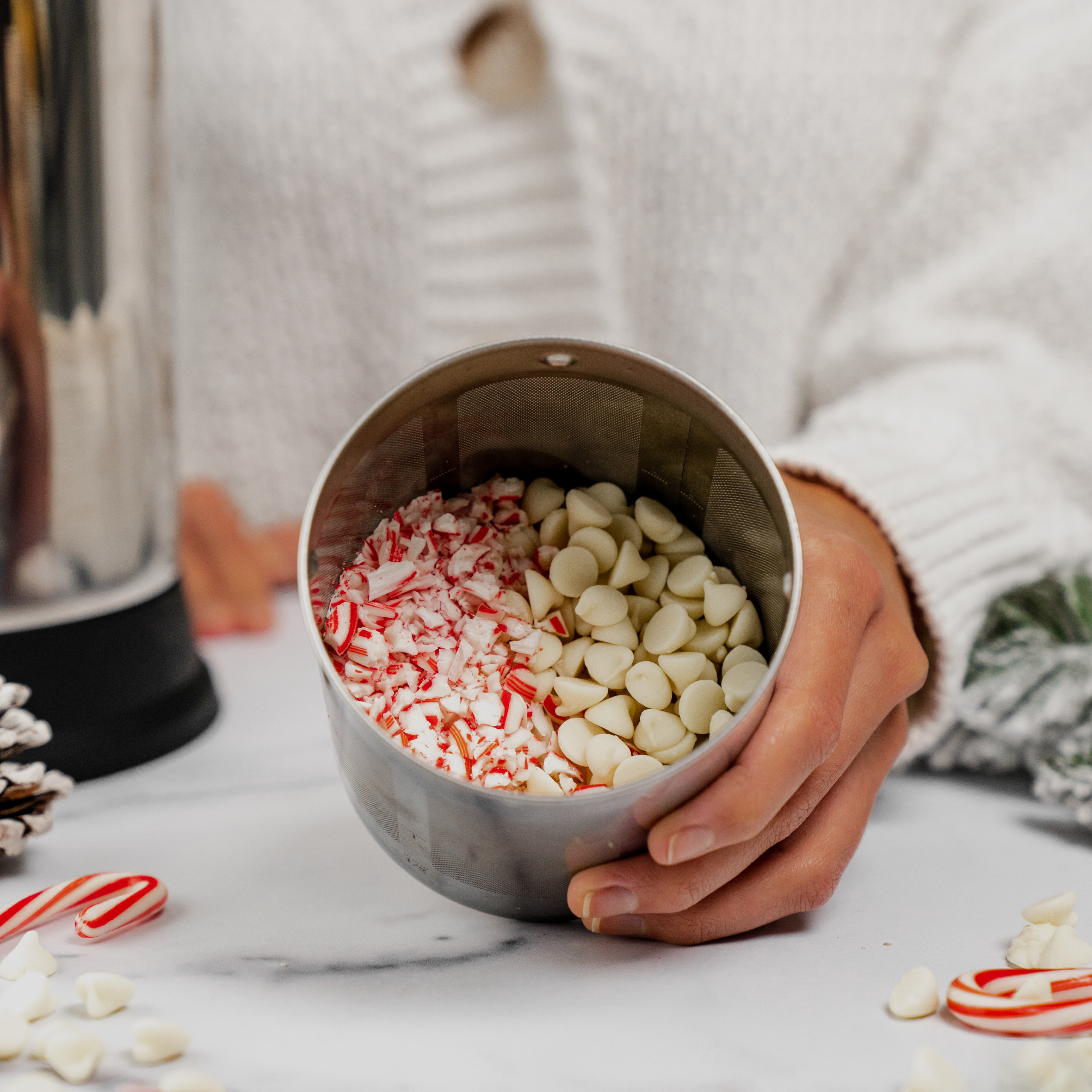 peppermint and white chocolate chips in a filter basket of an Almond Cow machine