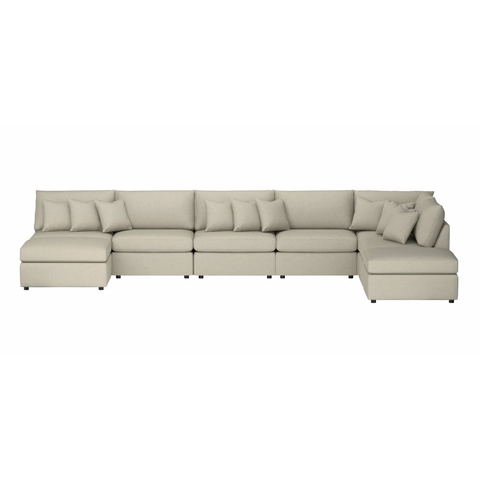 A light colored U-Shaped modular sofa