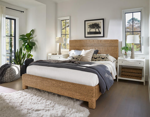 A beautifully decorated bedroom with a blue throw and decorative pillows