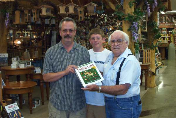 This photograph was taken 07/02/03 of Mr. Clyde A. Harbin Sr. with Mr. Rickey Fuller and son Todd Fuller.  Mr. Fuller told Mr. Harbin of his grandfathers tackle box of lures which he wanted to learn more about and find collector values for these lures.  Mr. Harbin suggested that he purchase a copy of "Old Fishing Lures & Tackle" by Carl F. Luckey with Clyde Harbin, Sr., "The Bassman".