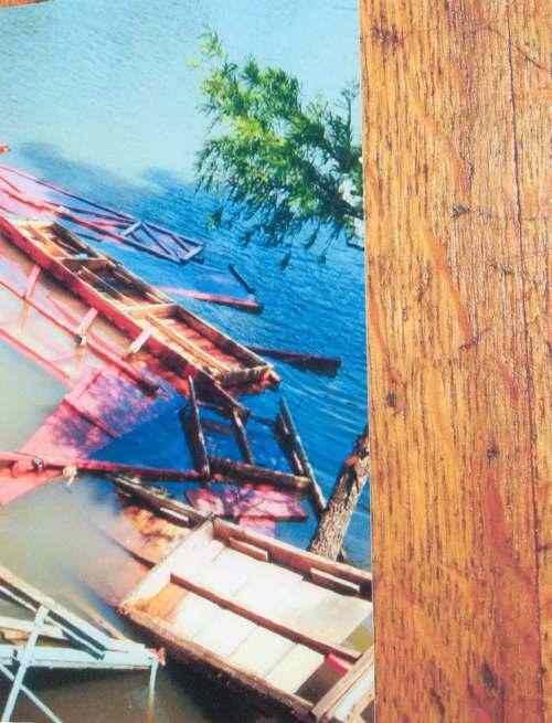 This is the only picture of Mr. Harbin's second boat dock which is upside down.  Sunk in East Lake it was destroyed by high winds on June 6, 1998.  The roof now rests on the lake bottom facing upward.  It is a great place for fish to hide...just right of the new dock which was built by Kelly Builders of Holly Grove, Arkansas June 28, 1998.