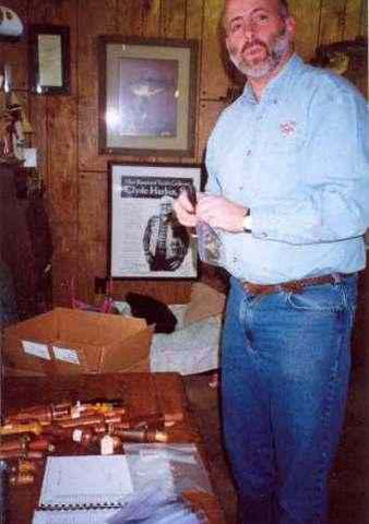 Rick Collins of Bass Pro Shops is wrapping and packaging the Bass Pro Shops 83 calls and hunting items for safe storage and a later date pick-up.